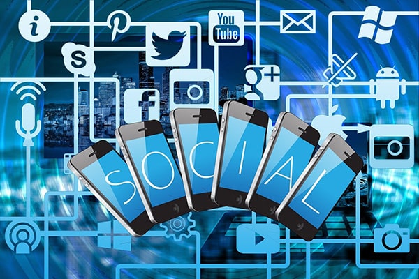 Image of various social media icons and the word SOCIAL spelled out onto six mobile phones to display how CPS provides social media marketing.